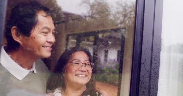 Mature Couple Enjoying View Winter Rain Window While Standing Talking — Vídeos de Stock