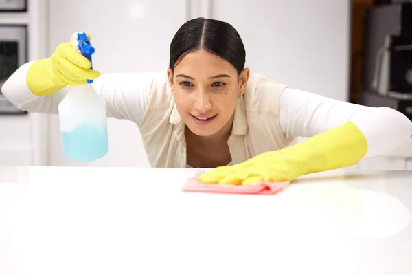 Young Woman Smiling While Cleaning Kitchen Counter — Stockfoto