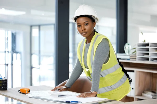 a female engineer drawing up blueprints.