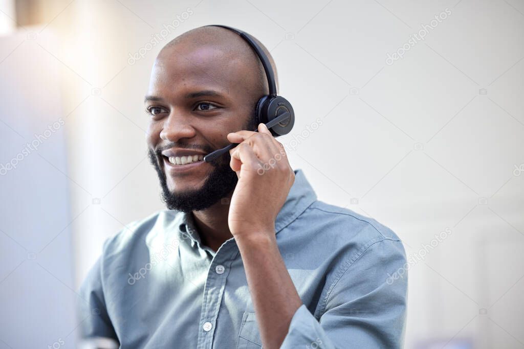 a young male call center agent working in an office.
