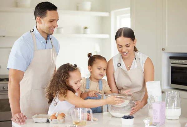 a young family baking together at home.