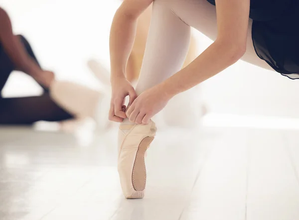 a unrecognizable female preparing for dance class.