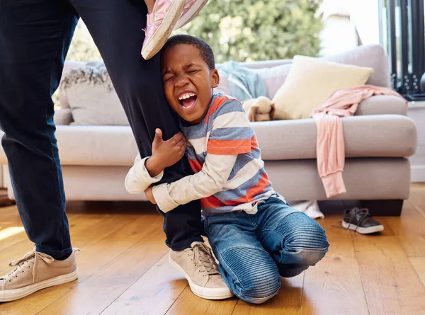 Little Boy Throwing Tantrum While Holding His Parents Leg Home — Stockfoto