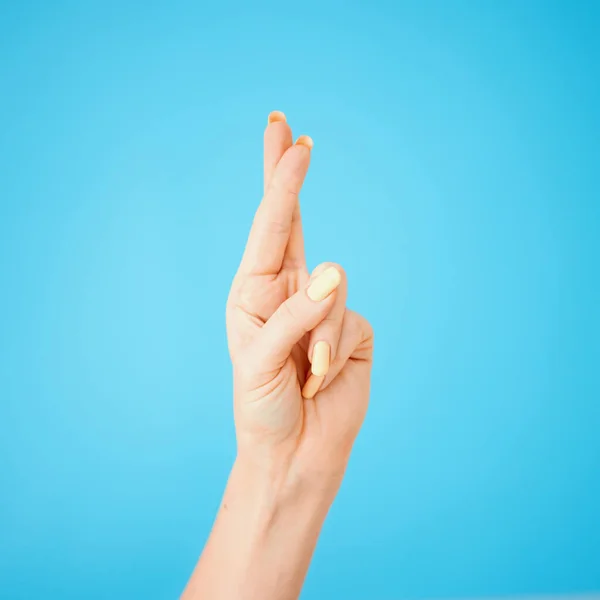 Studio Shot Unrecognisable Woman Crossing Her Fingers Blue Background — Stockfoto
