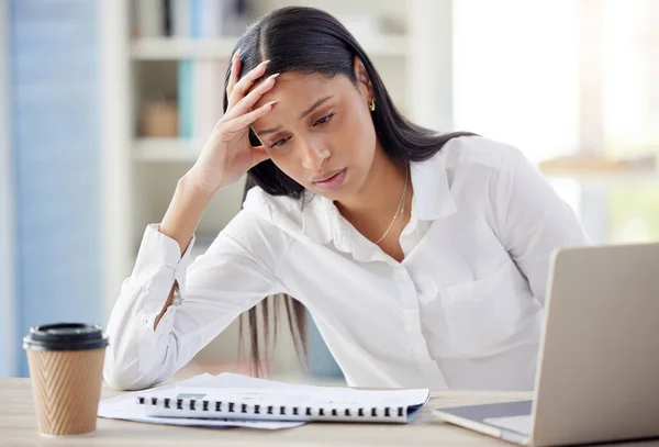 a young businesswoman looking exhausted at work.