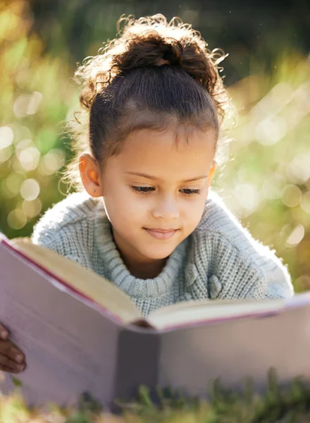 Little Girl Reading Book While Relaxing Park Garden Mixed Race — Stock fotografie