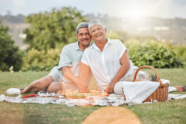 a mature couple enjoying a picnic.