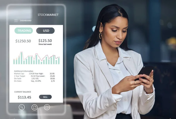 an unrecognisable businesswoman standing in her office at night and using her cellphone to check the stock market.