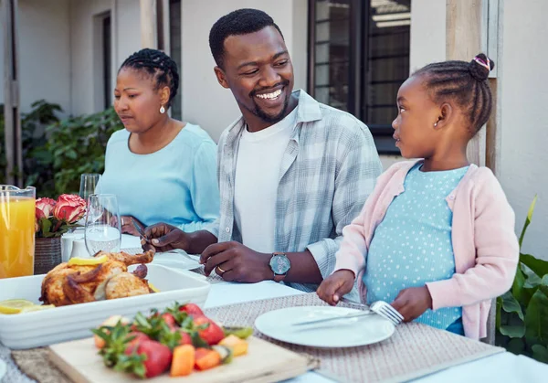 a happy family having lunch together outside in the garden.