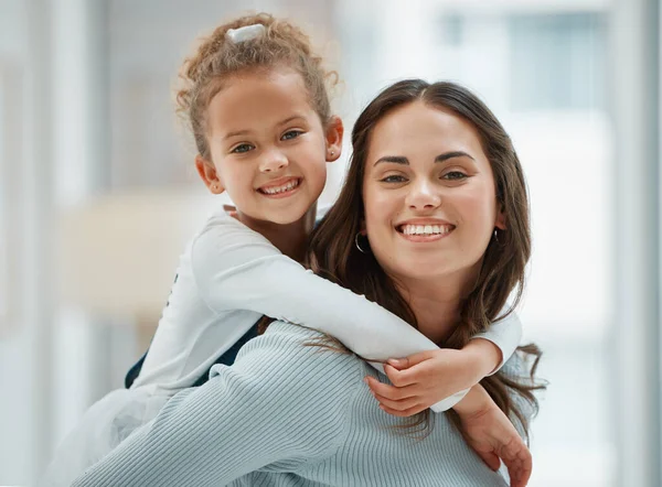 Young Mother Giving Her Daughter Piggyback Ride — Stockfoto