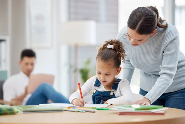 Young Mother Helping Her Daughter Her Homework Home — Stockfoto