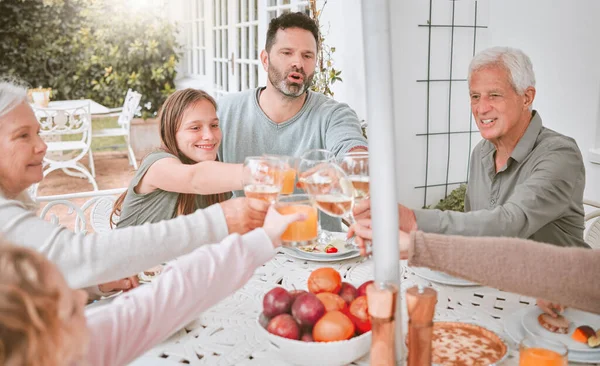 a family toasting with wine glasses at home.