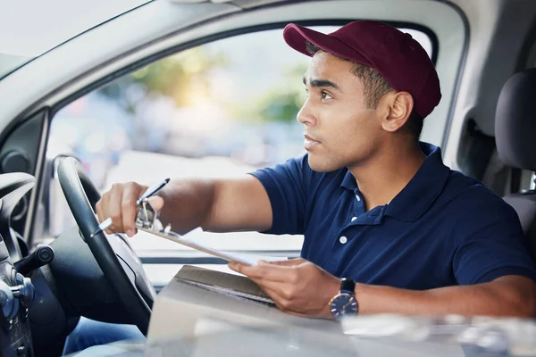 Young Delivery Man Writing Clipboard While Sitting Van — Stockfoto
