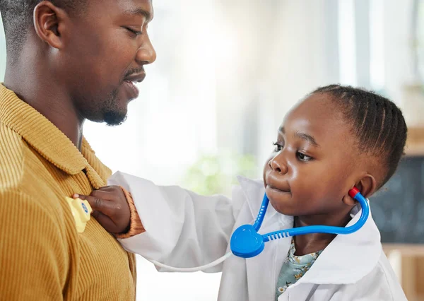 Little Girl Pretending Doctor While Playing Her Father — Stockfoto