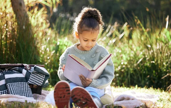 Little Girl Reading Book While Relaxing Park — Stockfoto