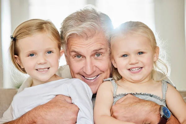a grandpa and his granddaughters at home.