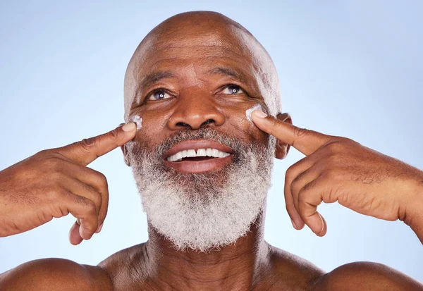 Studio Shot Mature Man Applying Moisturiser His Face Blue Background — Fotografia de Stock