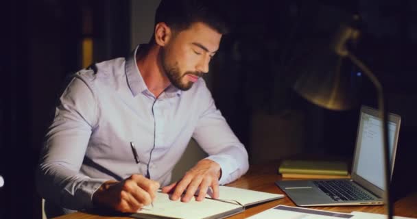 Young Business Man Working Overtime Taking Notes Writing Diary While — Stockvideo