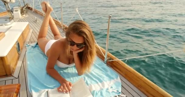 Young Woman White Bikini Relaxing Reading Book Yacht Sailing Italian — 图库视频影像