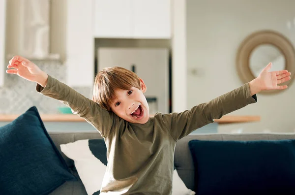 Portrait Cute Little Boy Expressing Excitement While Sitting Sofa Home — Foto Stock