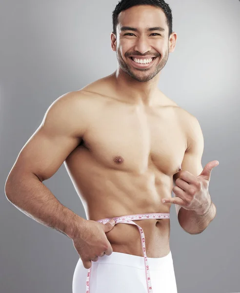 Studio Portrait Man Measuring His Waist Using Measuring Tape Grey — Photo