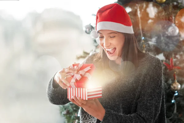 Young Woman Opening Christmas Gift Home — Stock Fotó