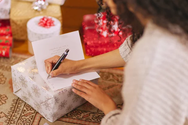 Unrecognisable Woman Writing Message Card Christmas Home — Stockfoto