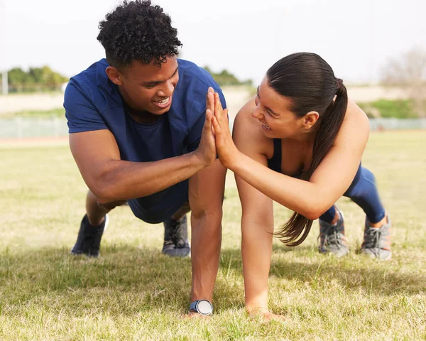 Two Workout Partners High Fiving Push Ups — Stok fotoğraf