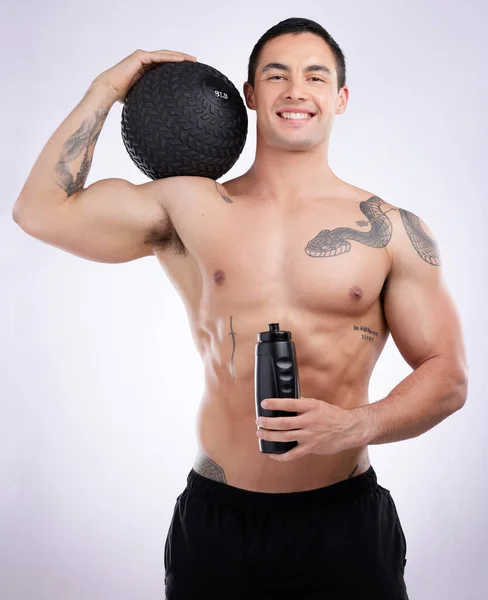 Male Athlete Holding Medicine Ball Water Bottle Studio Background — Foto de Stock