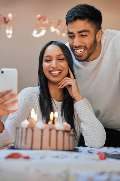 Young Couple Using Cellphone While Celebrating Birthday Home — Foto Stock