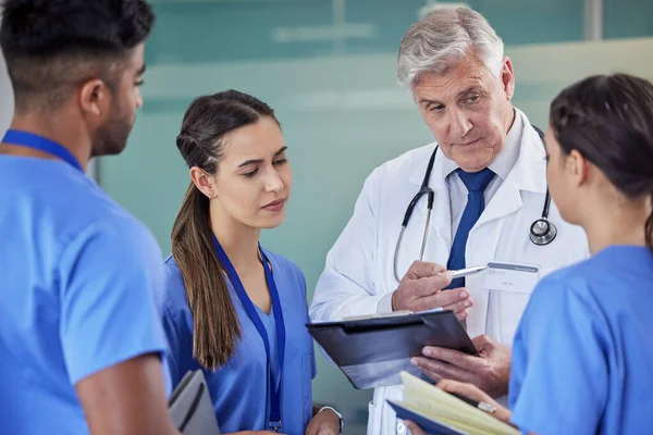 a group of doctors having a meeting at a hospital.