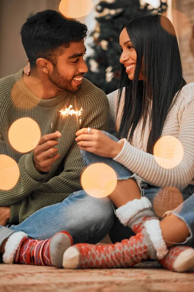 Young Couple Holding Sparklers While Celebrating Christmas Together Home — Stockfoto