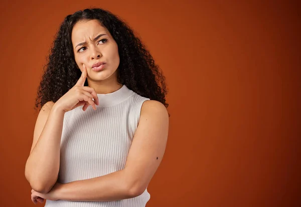 Attractive Young Woman Looking Thoughtful Studio Red Background — ストック写真