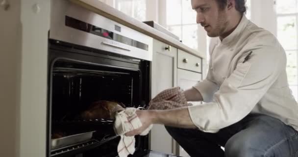 Young Chef Taking Chicken Out Oven Home — Stock Video