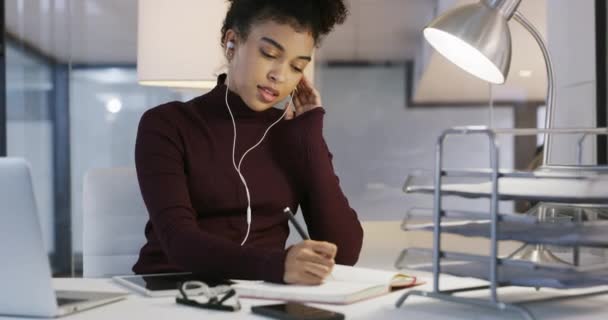 Video Footage Young Businesswoman Writing Notebook Using Earphones Modern Office — Vídeo de Stock