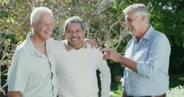 4k video footage of a group of male elderly friends spending time in a garden having fun.