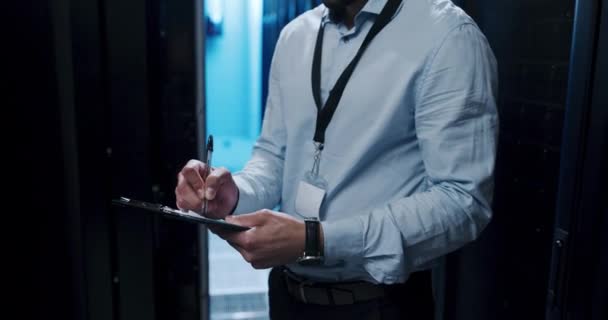 Video Footage Young Man Making Notes While Working Server Room — 图库视频影像