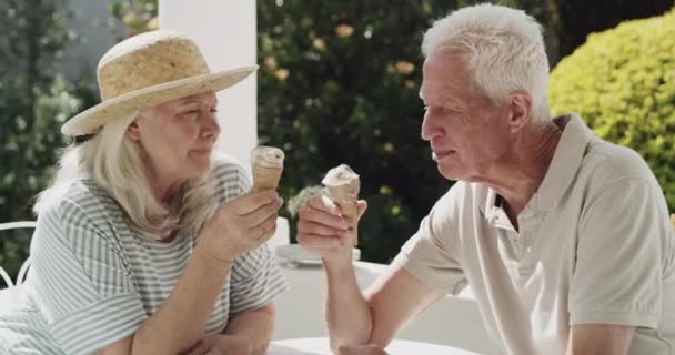 Video Footage Senior Couple Eating Ice Cream Cones While Sitting — Stockvideo