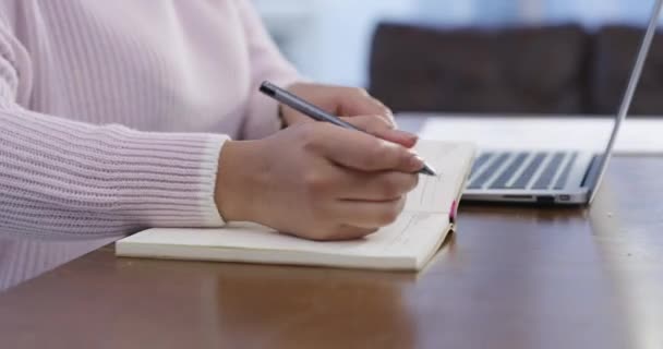 Video Footage Woman Making Notes While Using Her Laptop — Vídeos de Stock