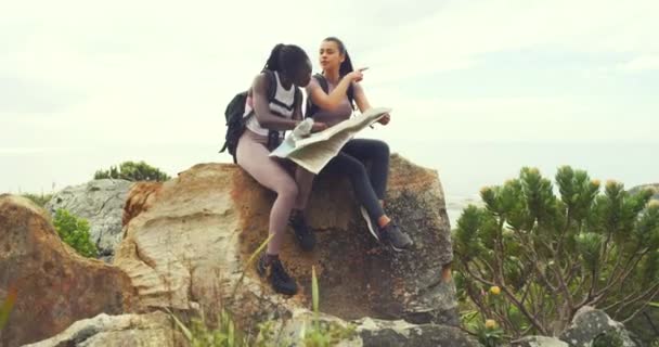 Two Women Hiking Looking Map Sitting Rock Sky Background Copyspace — Video