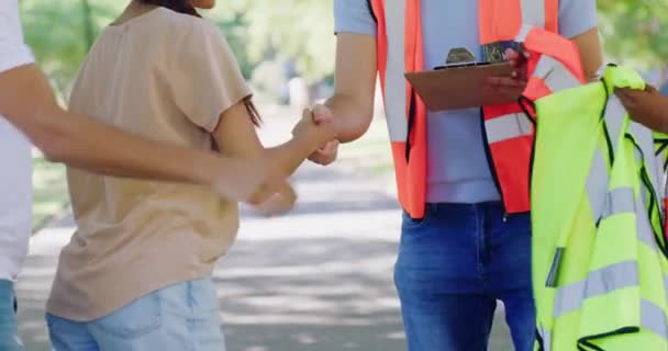 Volunteers Greeting Handshake Meeting Other Charity Staff Help Clean Park — стоковое видео