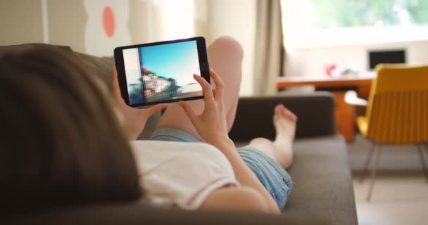 Woman Relaxing Looking Photos Her Digital Tablet — Vídeo de Stock