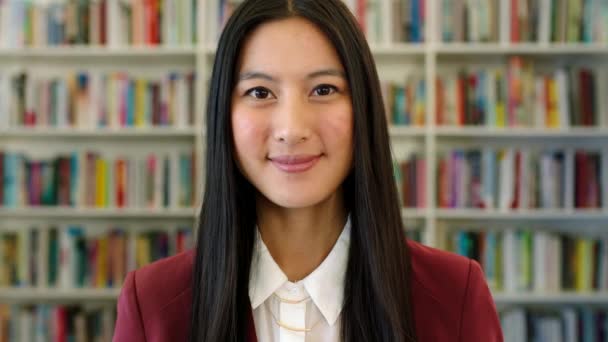 Okul Kütüphanesinde Gülümseyen Asyalı Bir Öğrencinin Portresi Kitapçıda Okuyacak Bir — Stok video