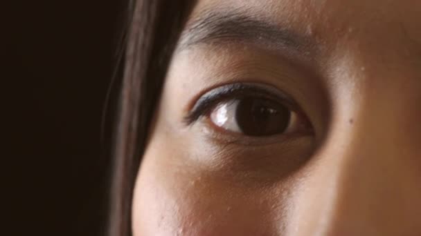 Closeup Female Eye Blinking Dark Studio Background One Caring Humanitarian — Vídeo de stock