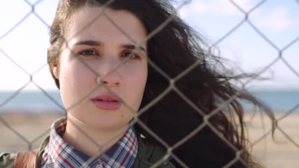 Sad Young Woman Standing Trapped Wire Fence Border Outdoors Portrait — Stockvideo