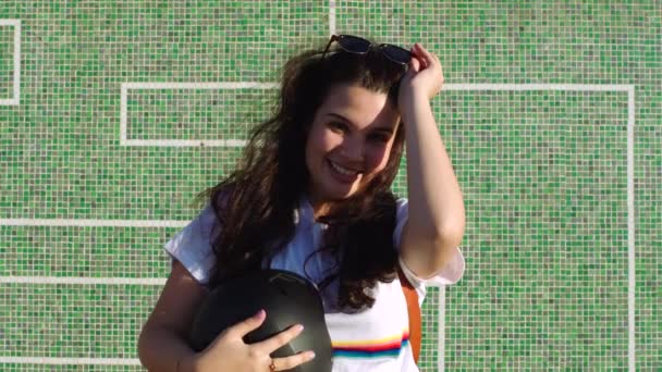 Young Female Skater Removing Her Helmet While Standing Green Wall — Wideo stockowe
