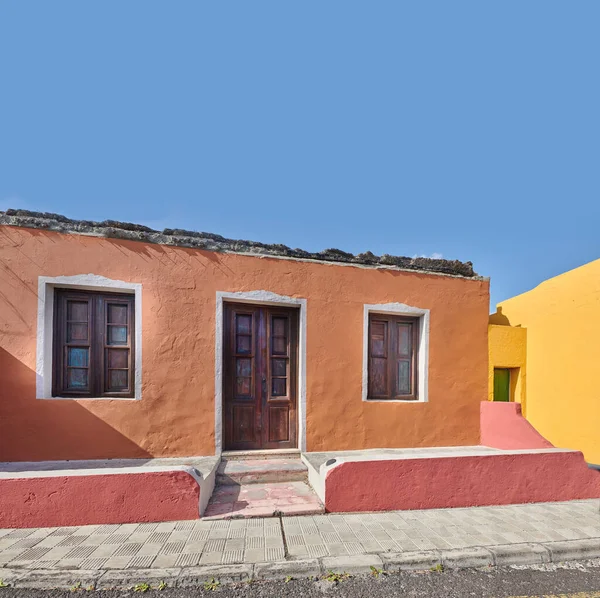 Colorful building in a vibrant city of Santa Cruz de La Palma with clear blue sky copyspace background on a sunny day. Bright residential houses in a village of a popular tourism destination overseas.