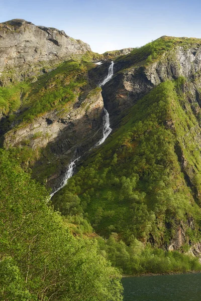 Mountain spring water flowing through a jungle thicket on an island, nature in its purest form. Beautiful landscape of clean river water coming down a rocky hill on a summer day outdoors in nature