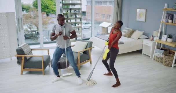 Video Footage Beautiful Young Couple Dancing While Doing House Chores – Stock-video