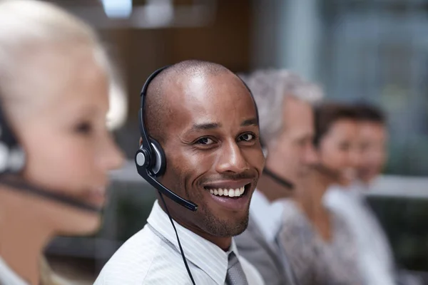 Portrait of a handsome african american customer service representative talking into a headset.